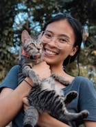 Guest holding a cat at CatWorld Samui