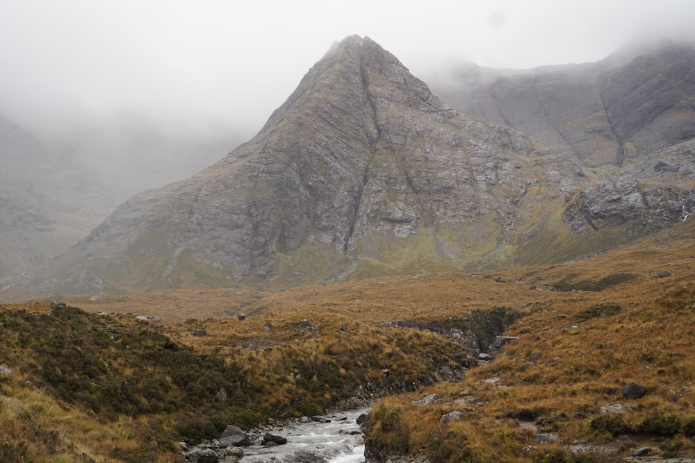 a mountain with a stream running through it