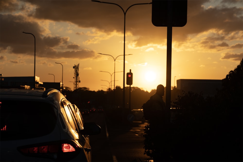 the sun is setting over a city street