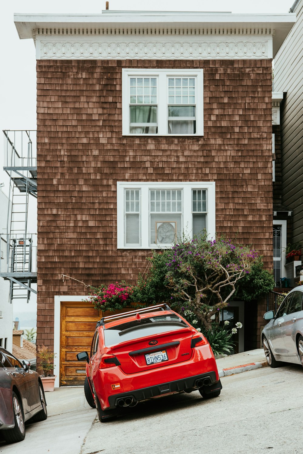 two cars parked in front of a house