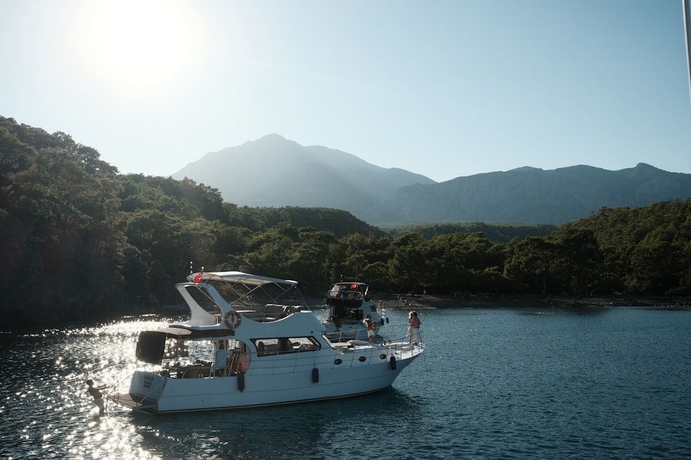 a white boat floating on top of a body of water