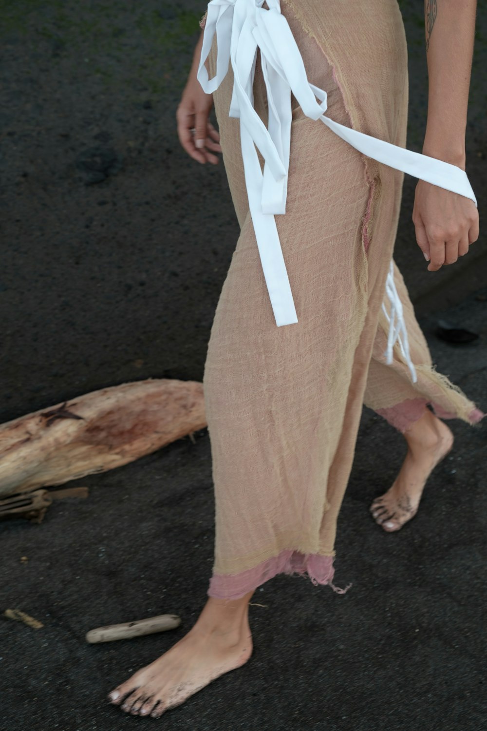 a woman wearing a white ribbon around her ankles