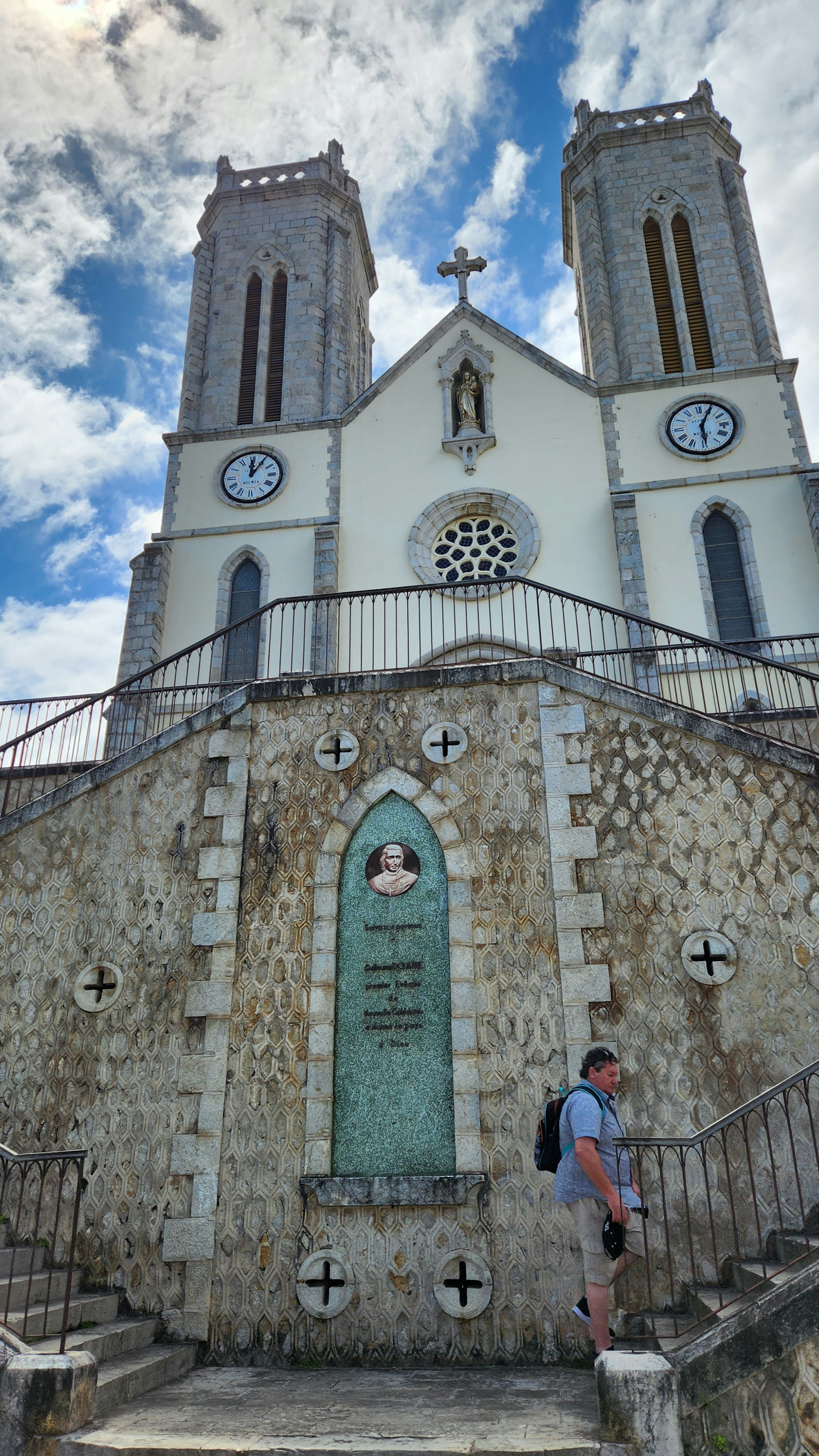 a man is standing in front of a church