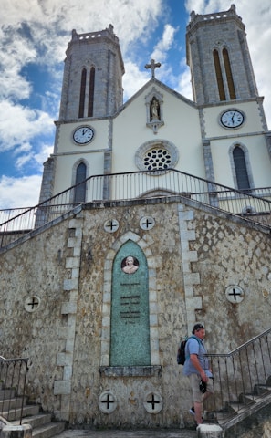 a man is standing in front of a church