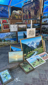 a bunch of paintings that are on the ground