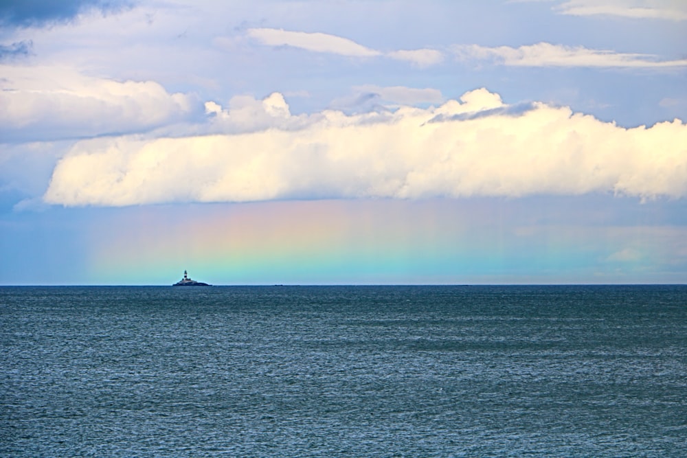 a large body of water under a cloudy sky