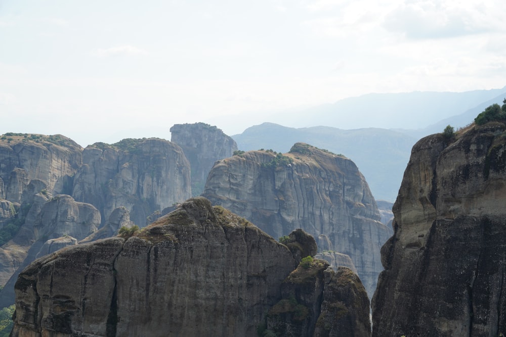 a mountain range with rocks and trees in the foreground