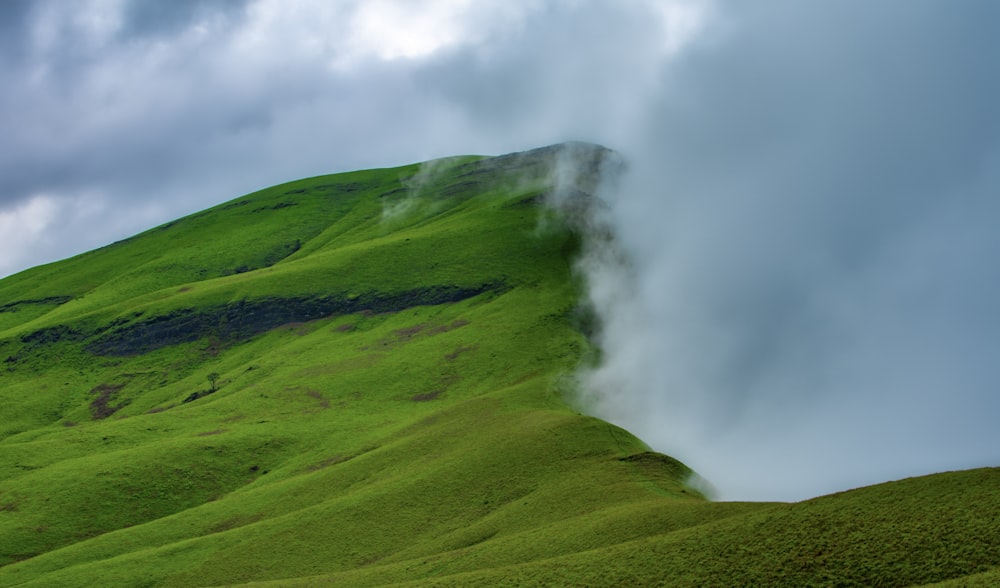 a green hill with a steam rising from it