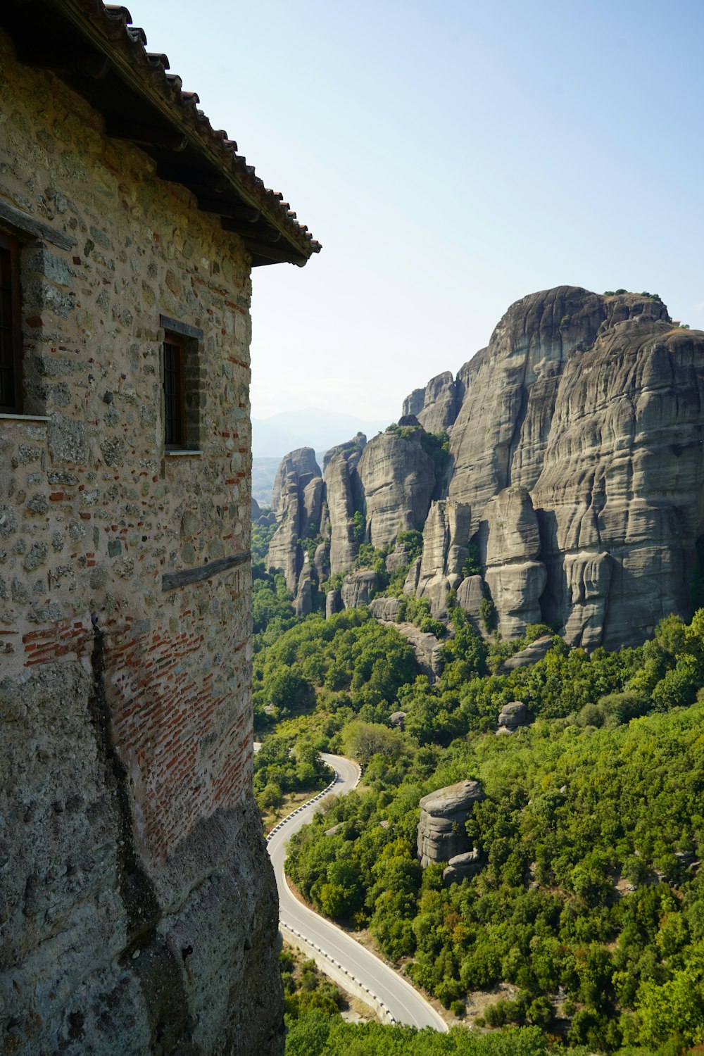 a scenic view of a mountain with a winding road in the foreground