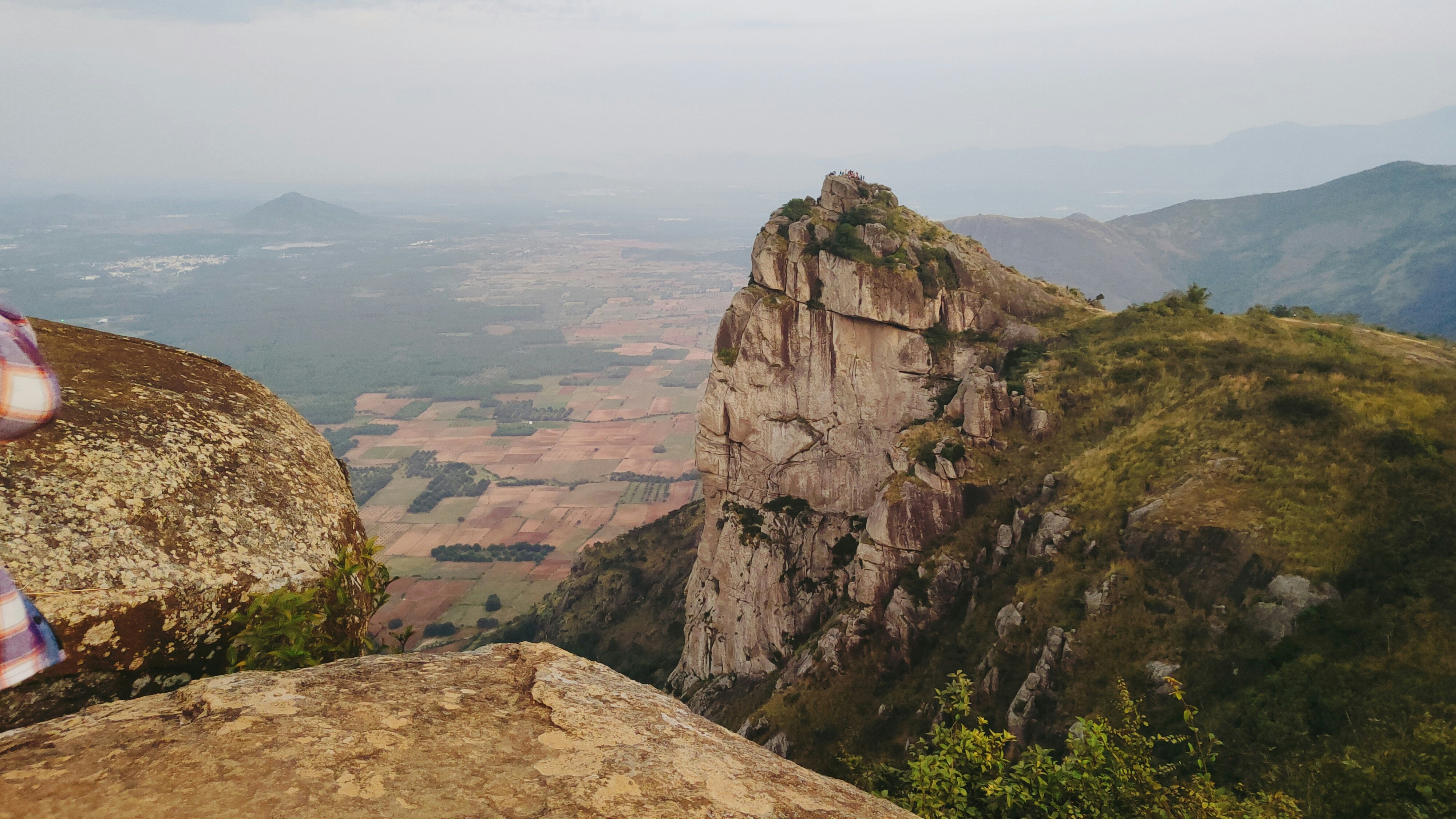 a person standing on top of a mountain overlooking a valley