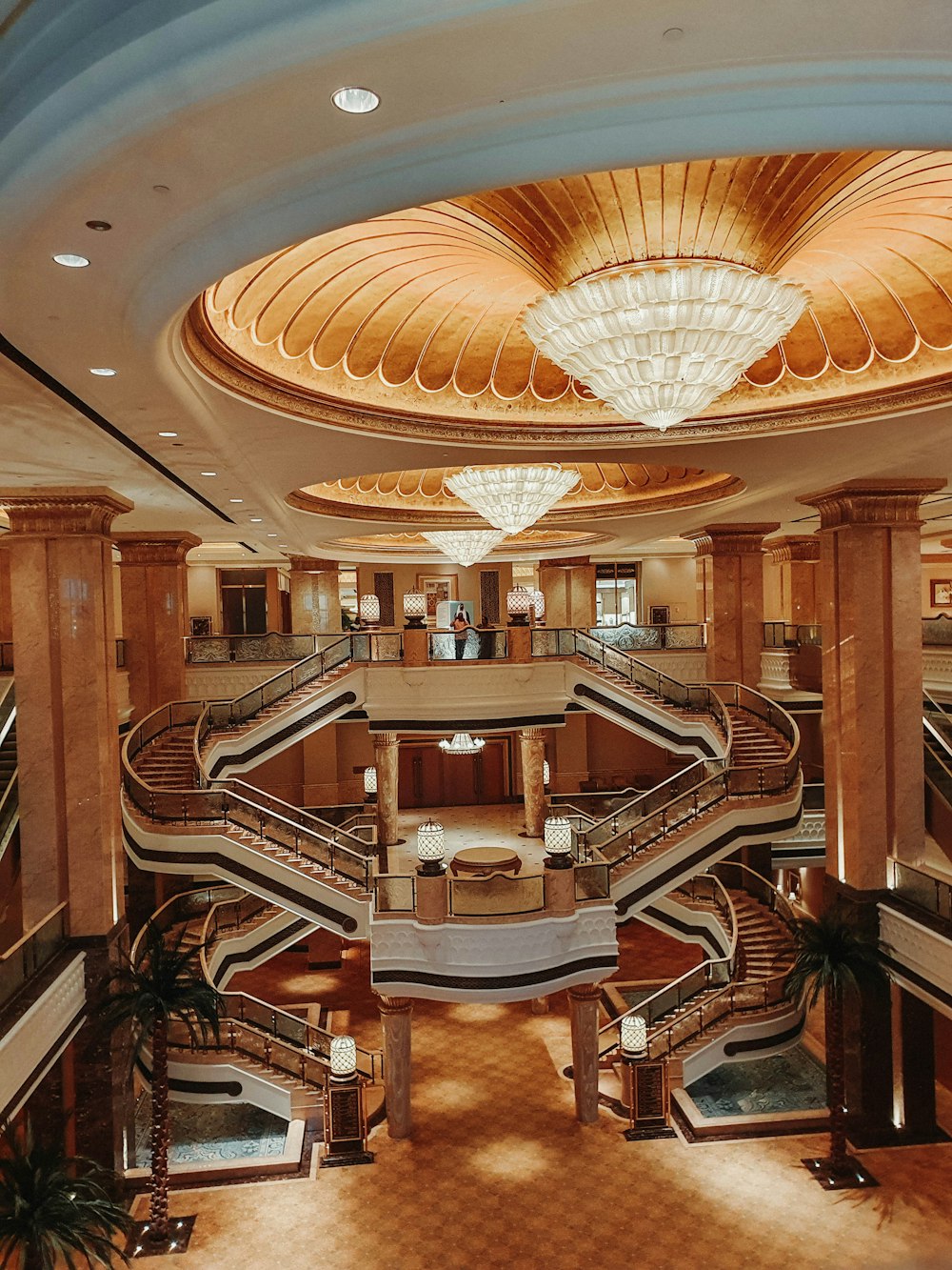 a large lobby with a spiral staircase and chandelier