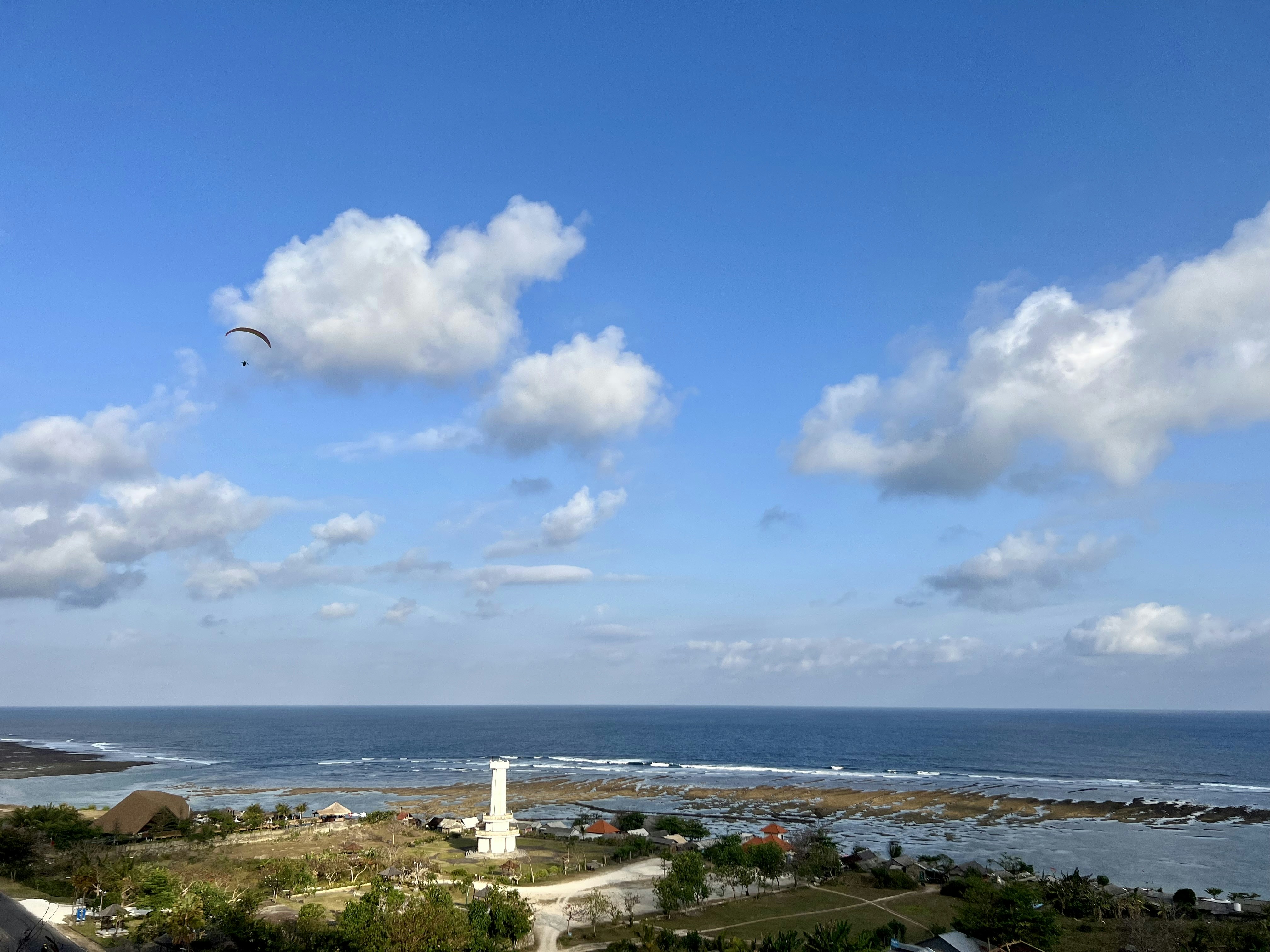 a view of the ocean from the top of a hill