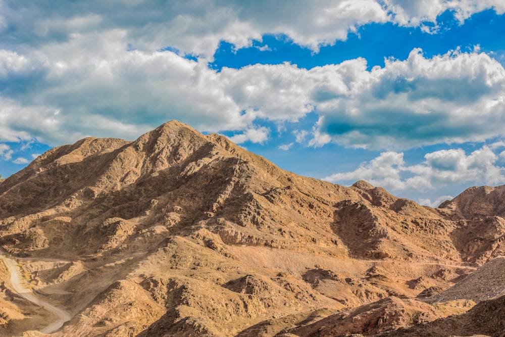 a view of a mountain range with clouds in the sky