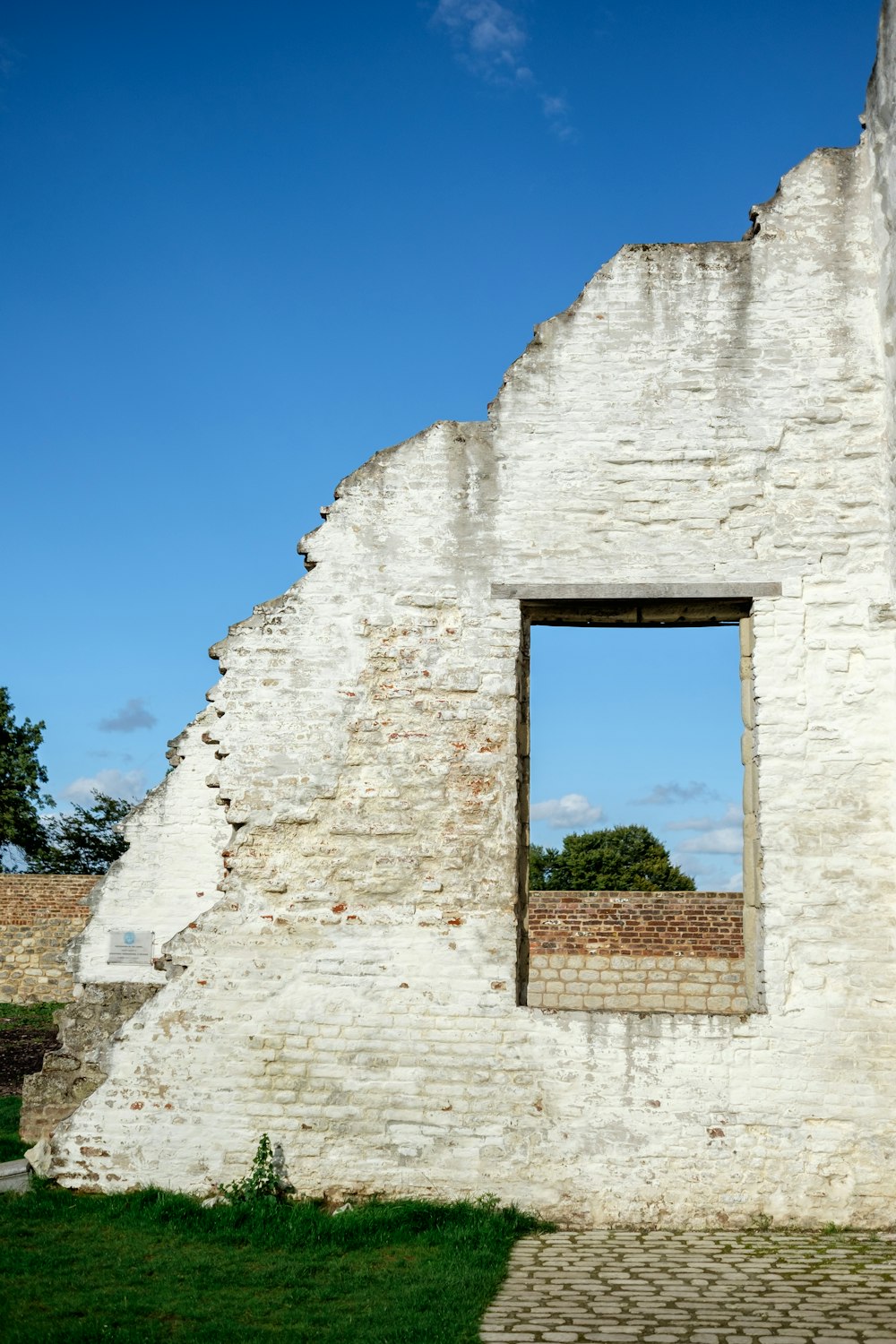 a white brick building with a small window