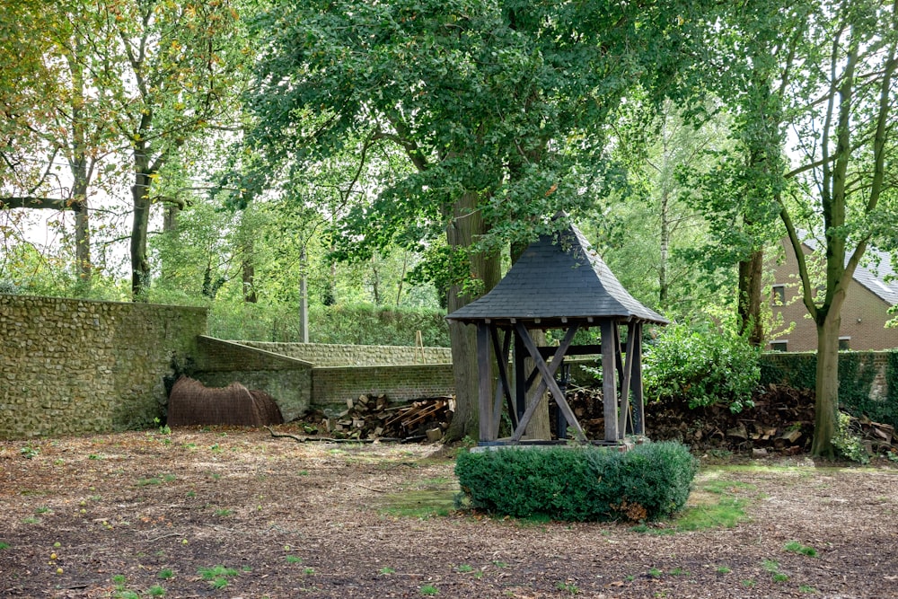 a small wooden structure in the middle of a field