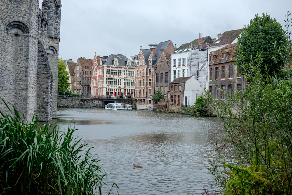 a river running through a city next to tall buildings