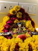 An ornate silver plate holding offerings for the Kankali Maa Puja, surrounded by marigold flowers.