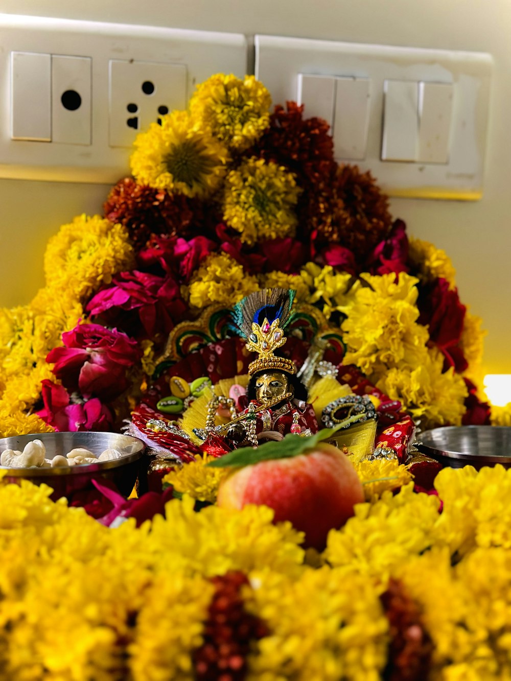 a statue of a person surrounded by flowers