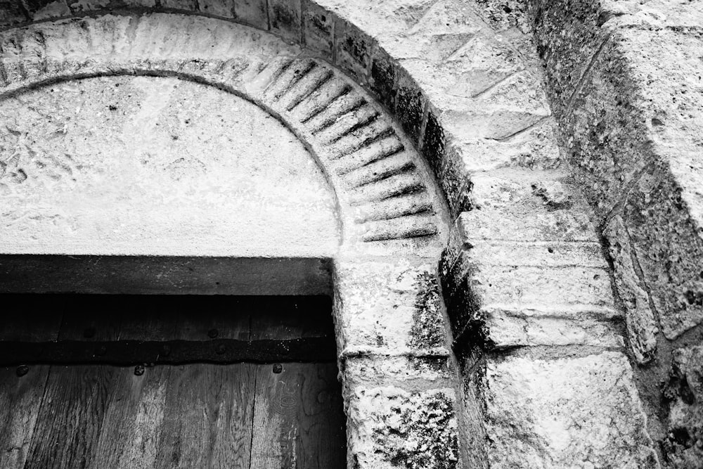 an old building with a wooden door and a brick wall