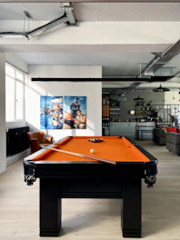 A skilled technician assembling a waterproof stone pool table in a bright Kampala showroom.