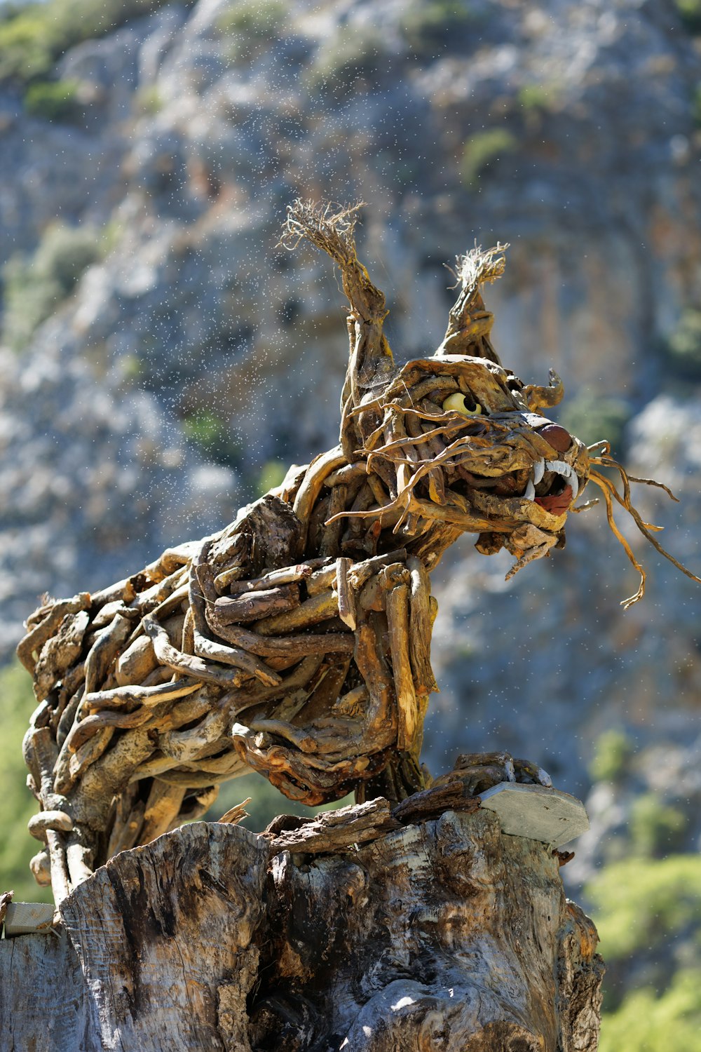 a sculpture of a dog made out of driftwood