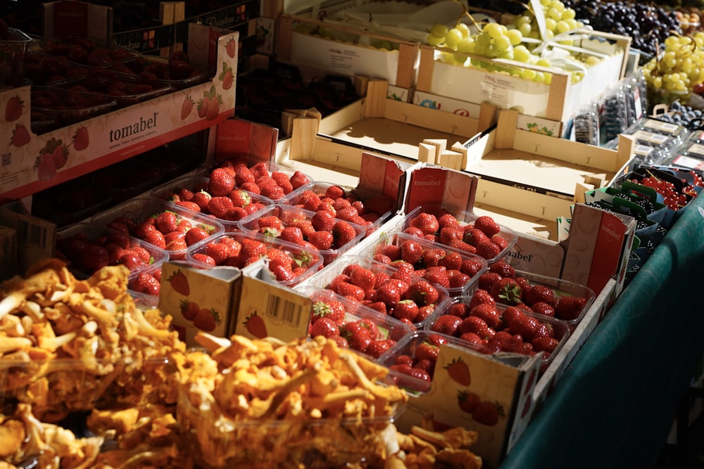 a fruit stand with strawberries and other fruits