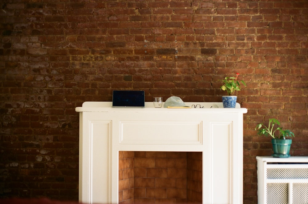 a living room with a brick wall and a fireplace