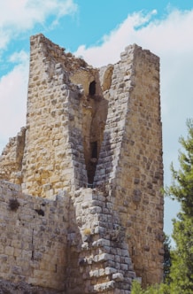 a very tall brick building with a small window