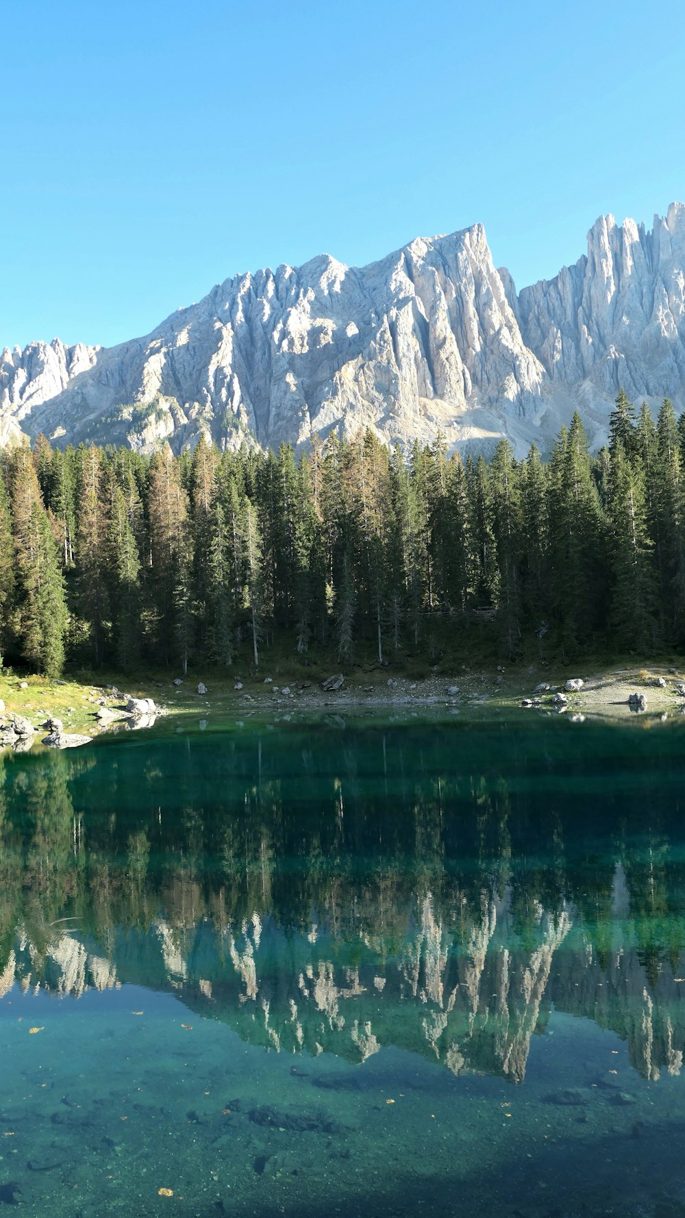 a mountain range is reflected in a lake