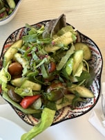 A fresh garden salad with ripe tomatoes, cucumbers, and a light vinaigrette.