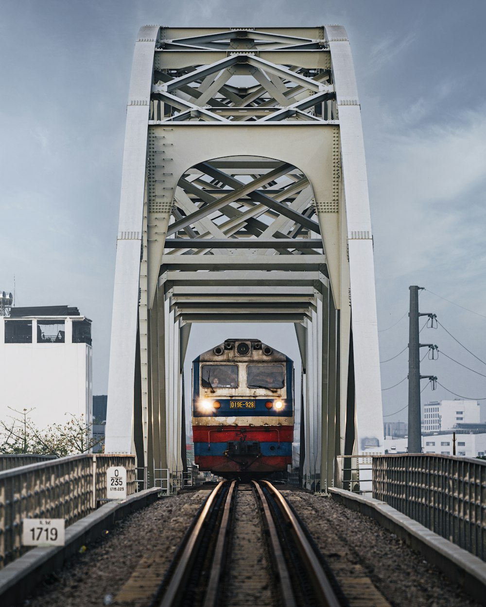 a train on a train track going under a bridge