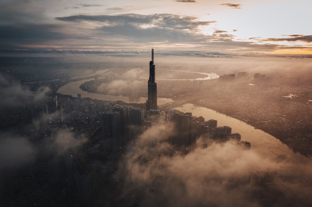 an aerial view of a city in the clouds