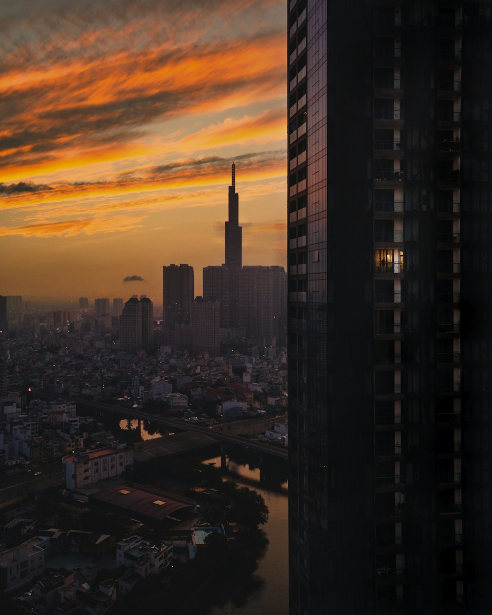 a sunset view of a city and a body of water