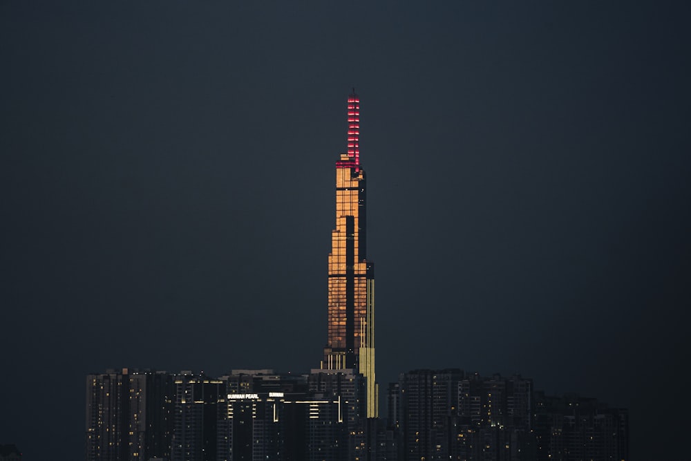 a tall building with a red light on top of it