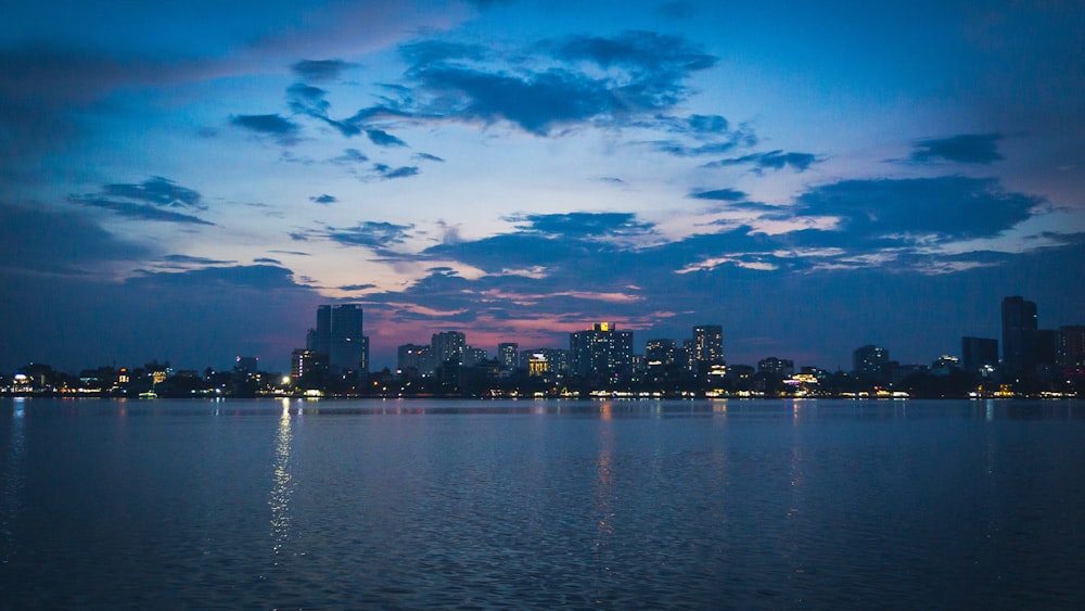 a large body of water with a city in the background