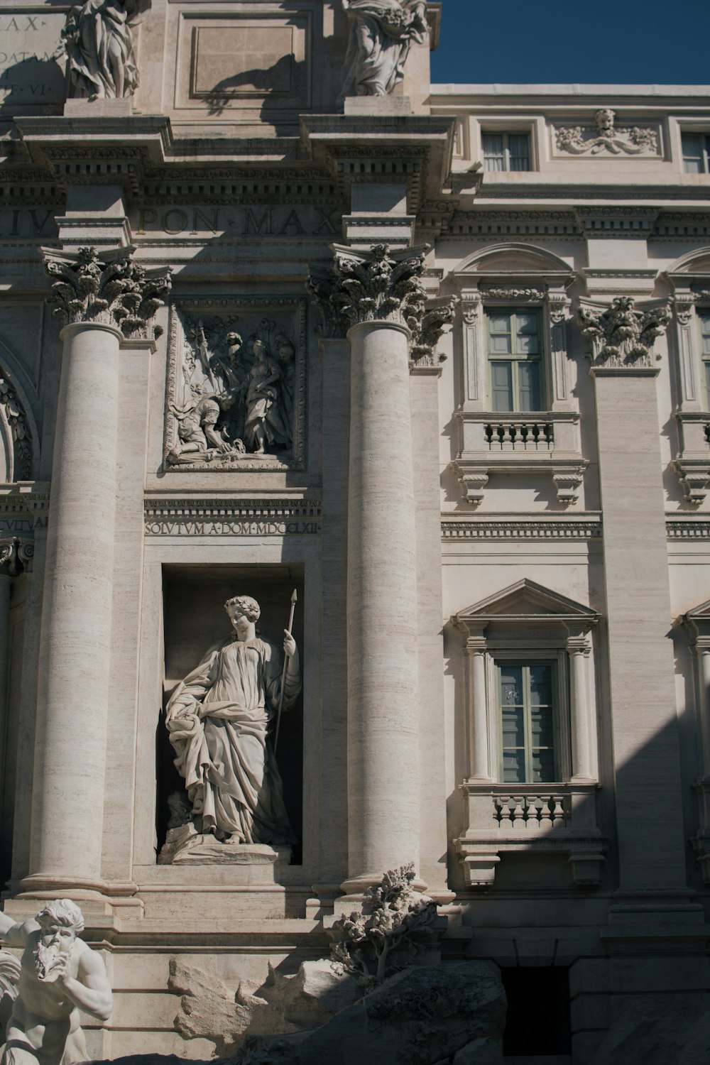 a large building with statues on the front of it