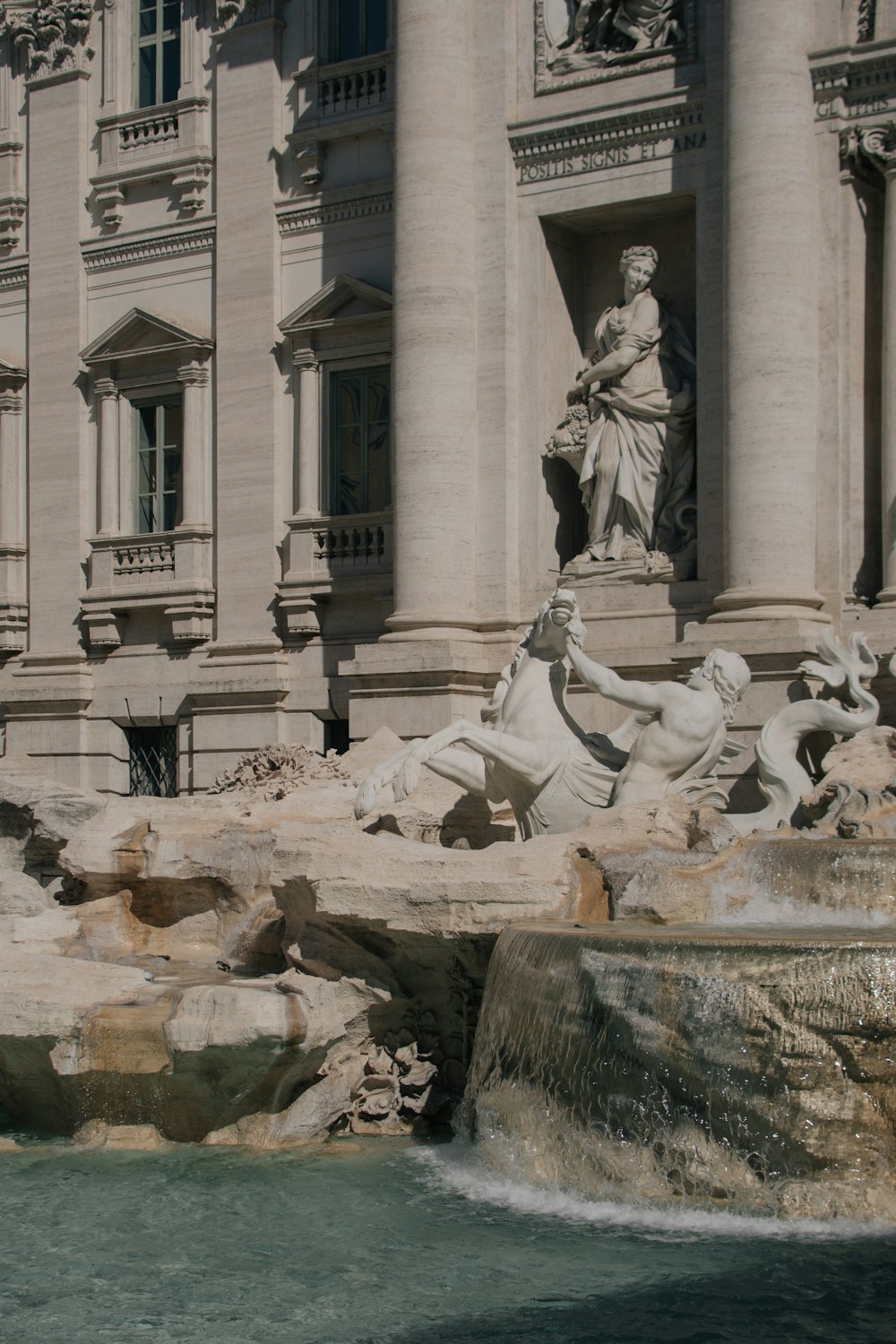 a large building with a fountain in front of it