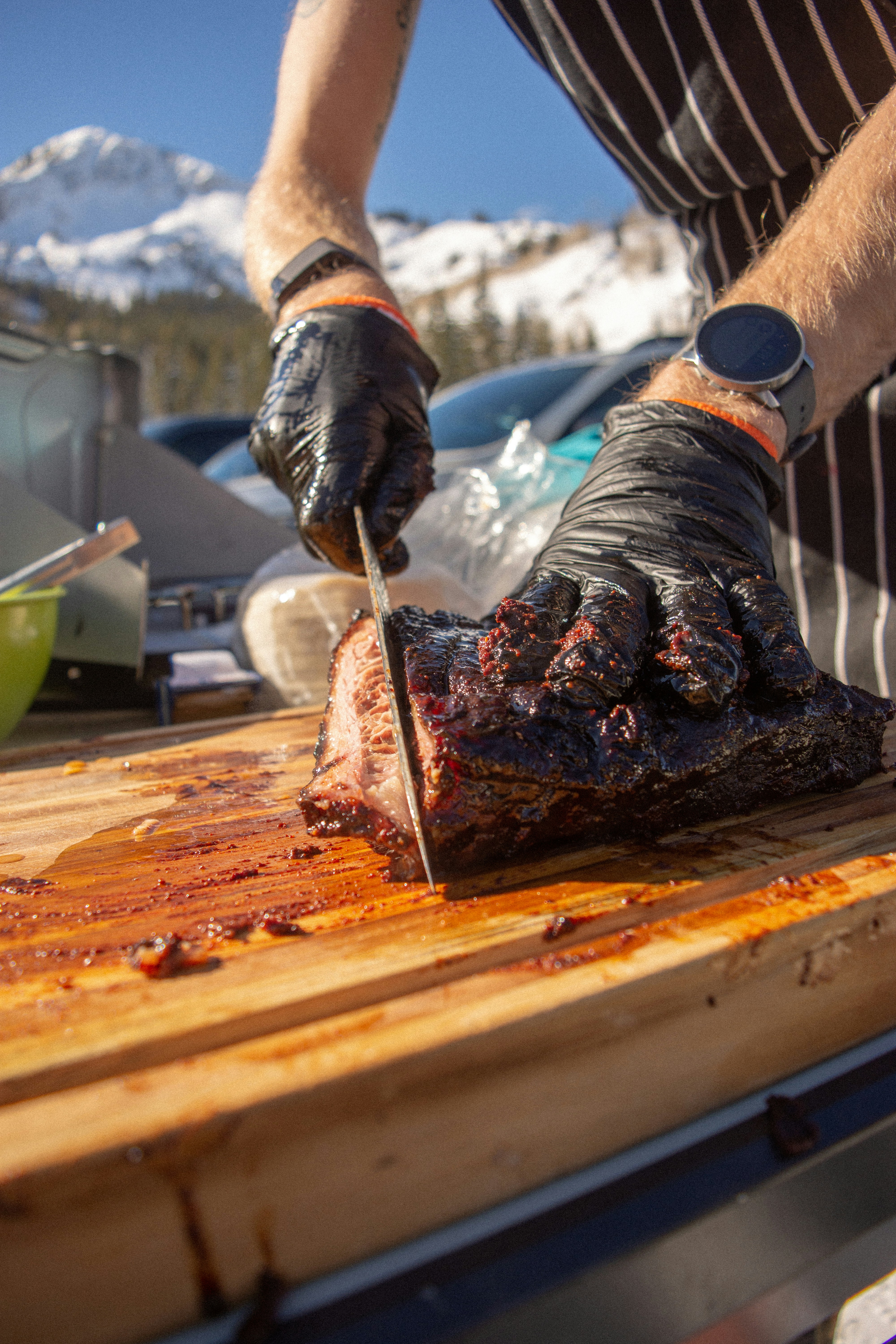 a man cutting up a piece of meat on a cutting board