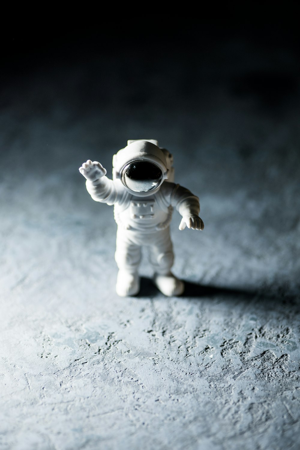 a small toy astronaut standing on the moon