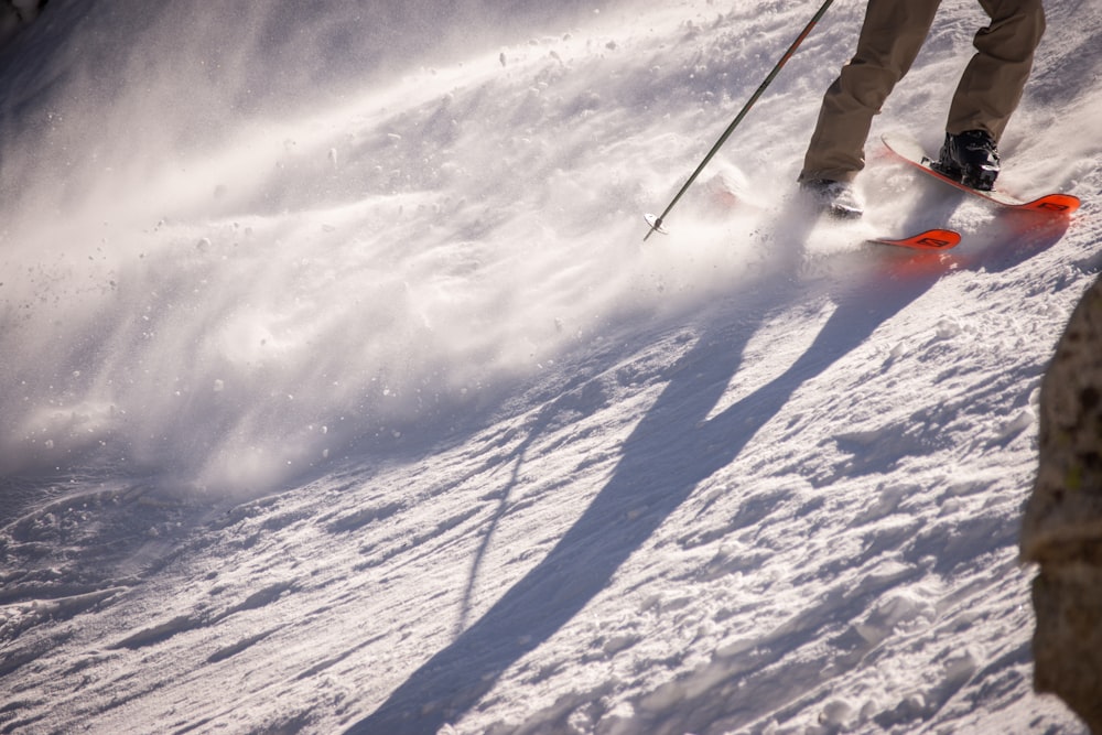 a person riding skis down a snow covered slope