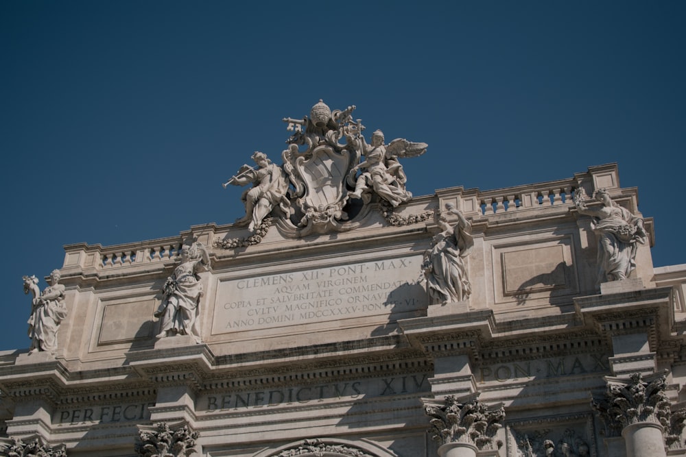 a large building with statues on top of it