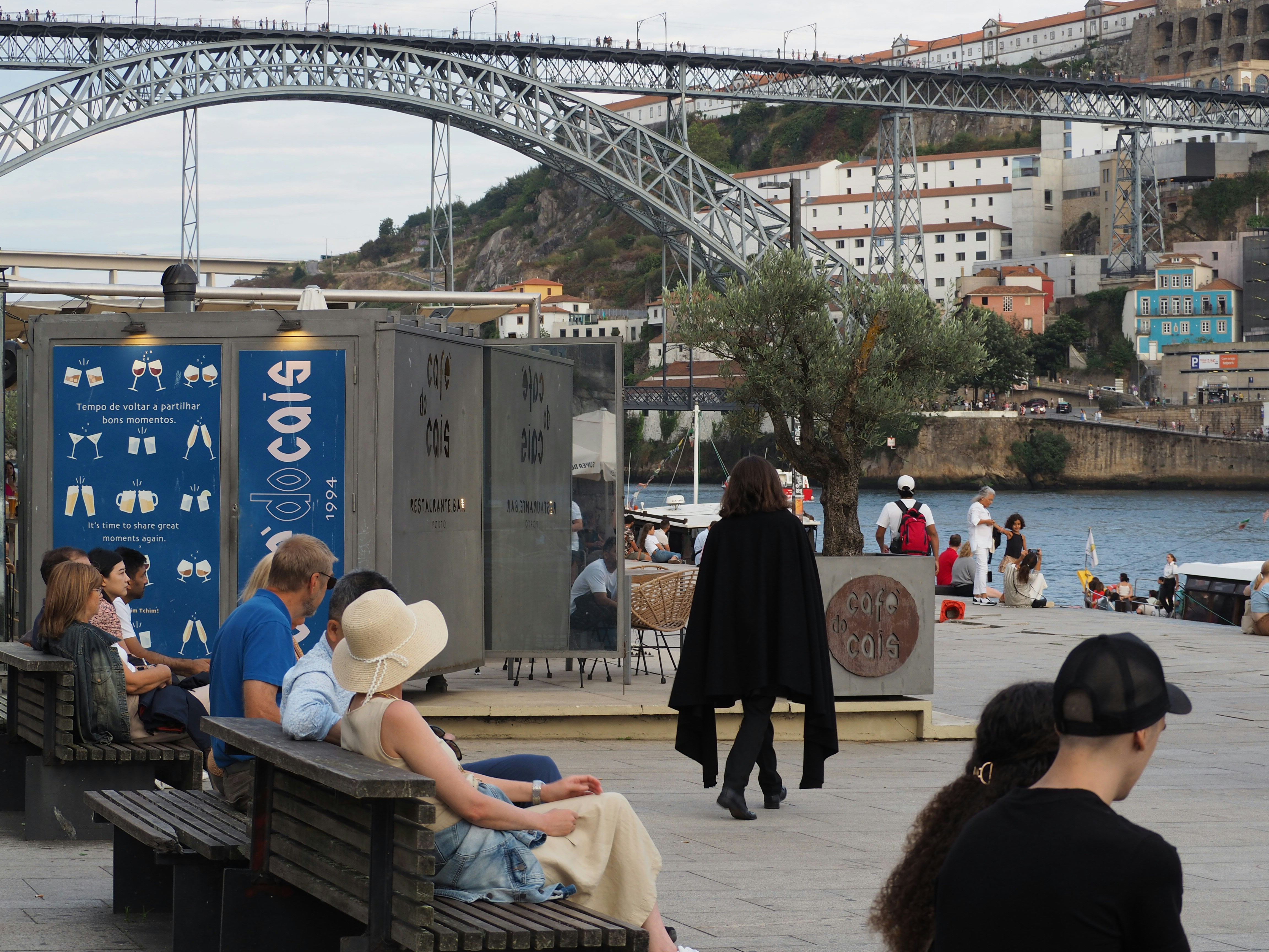 a group of people sitting on top of a wooden bench