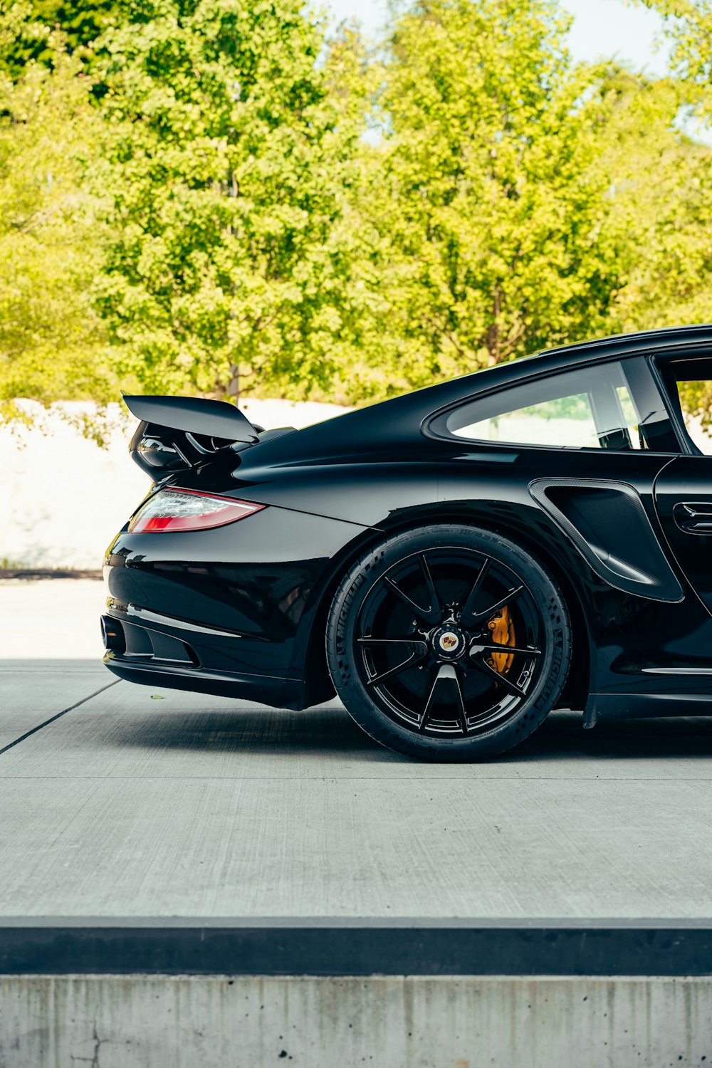 a black sports car parked in a parking lot