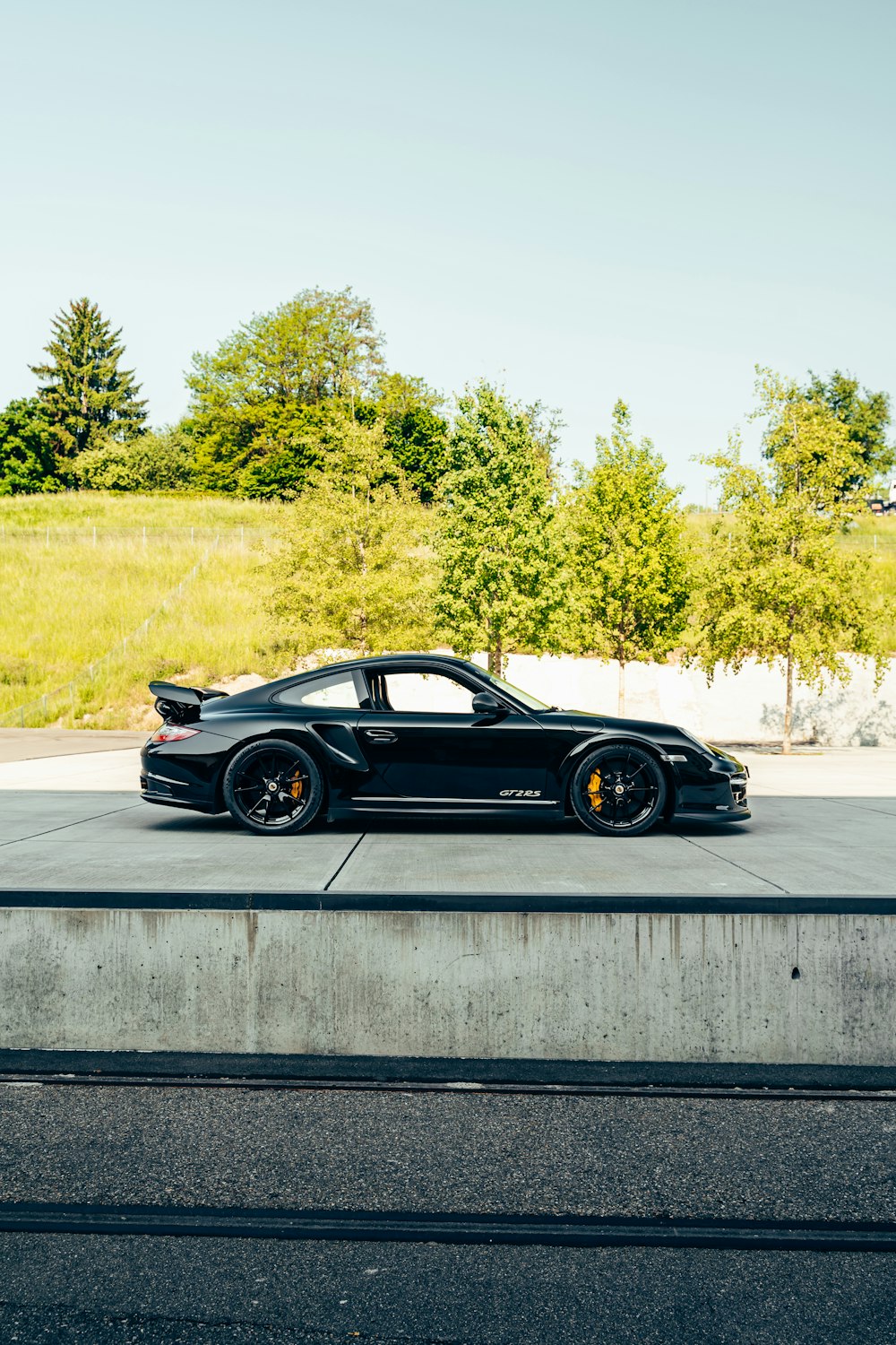 a black sports car parked in a parking lot