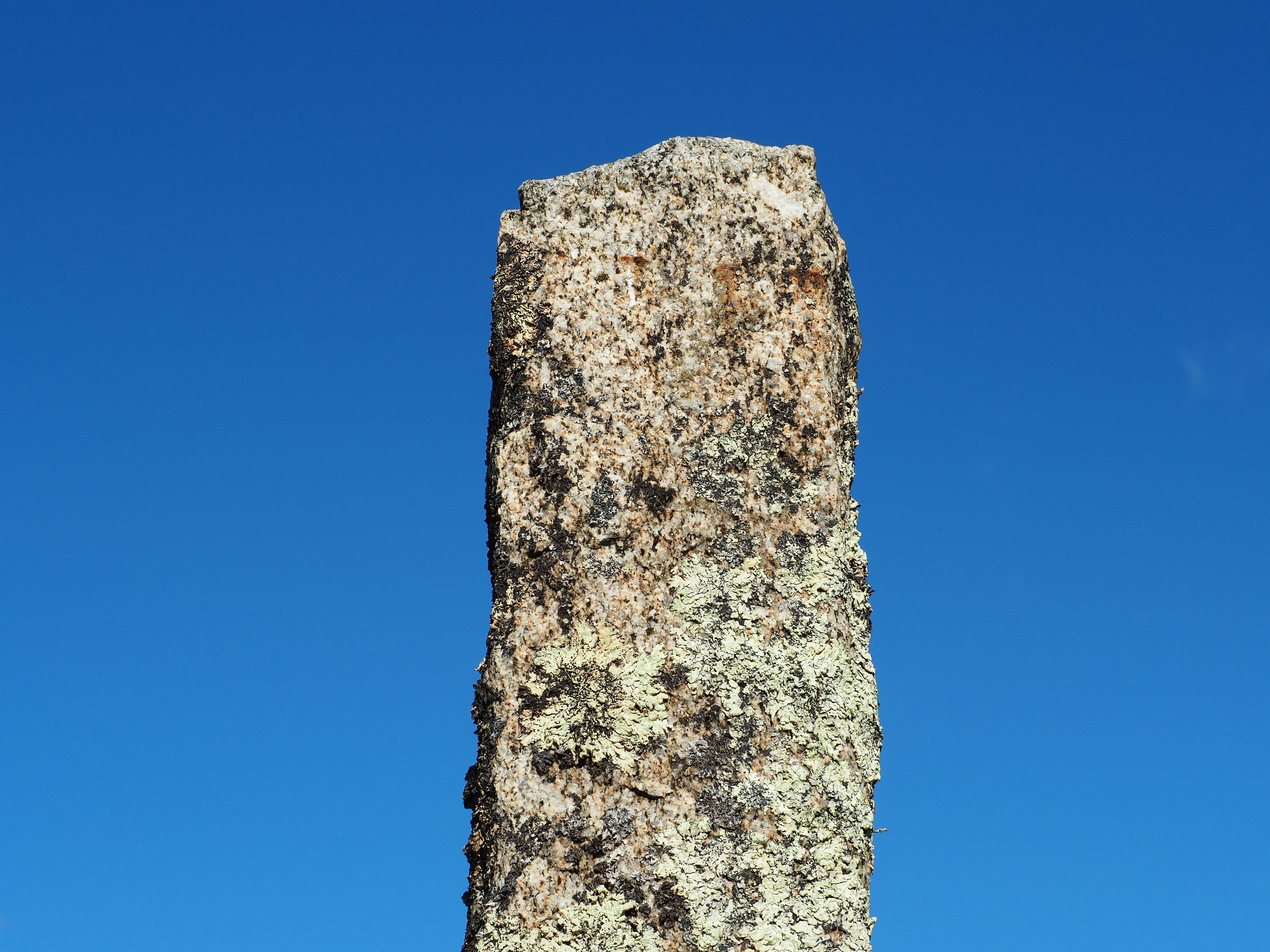 a large rock sticking out of the ground