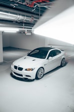 a white car parked in a parking garage
