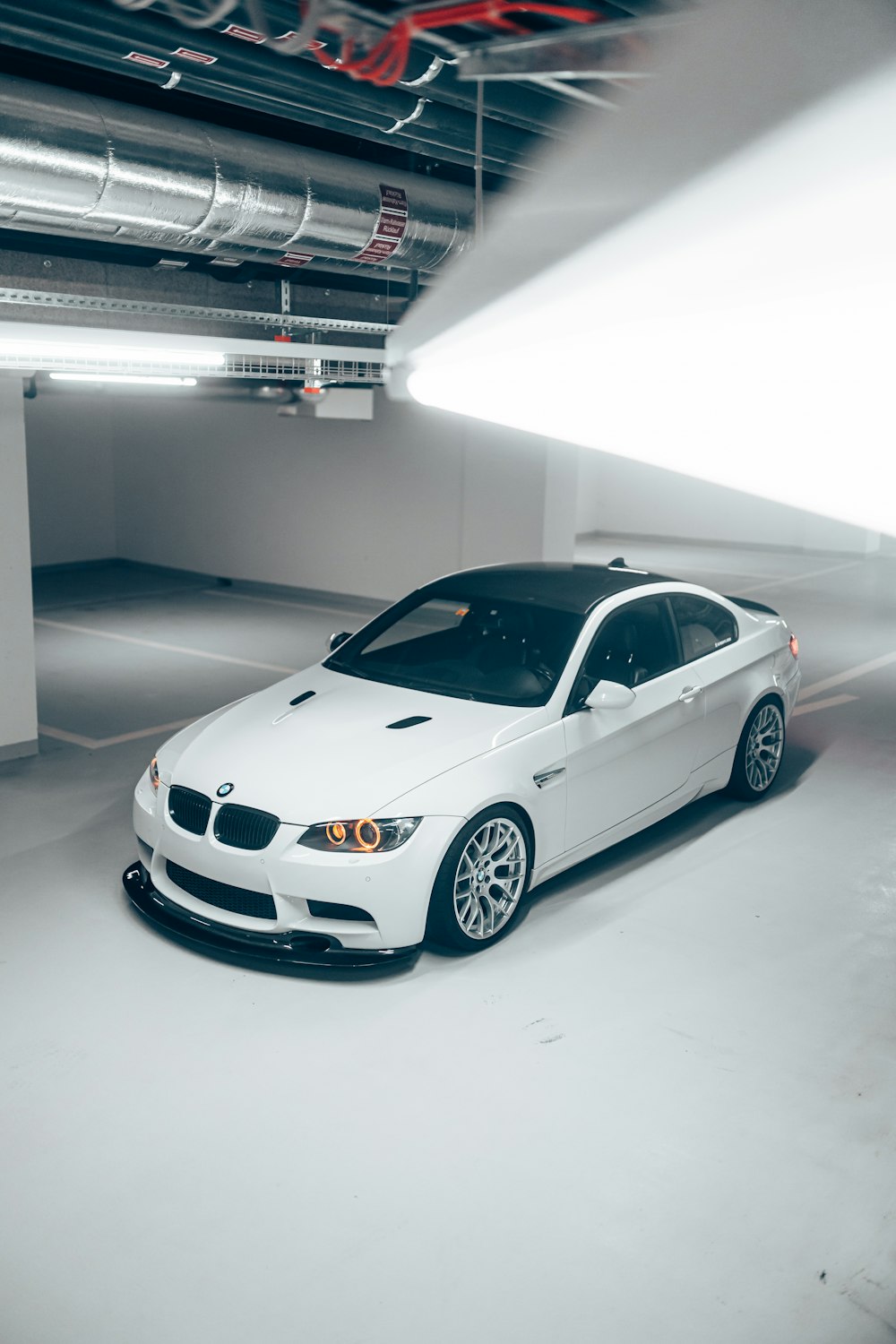 a white car parked in a parking garage