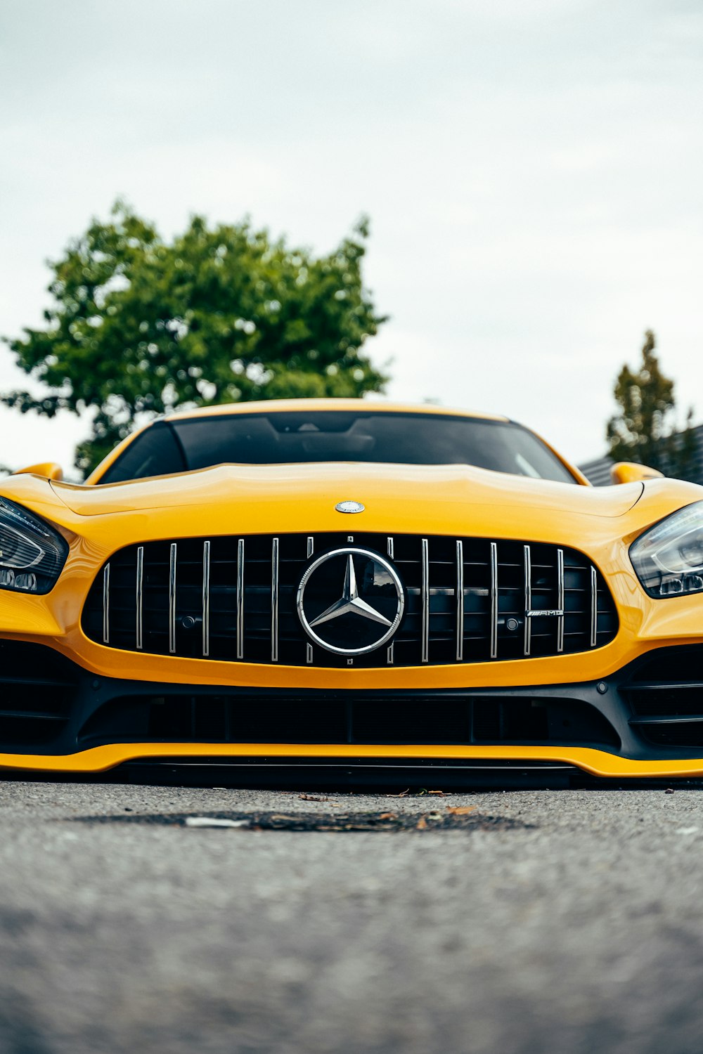 a yellow sports car parked on the side of the road