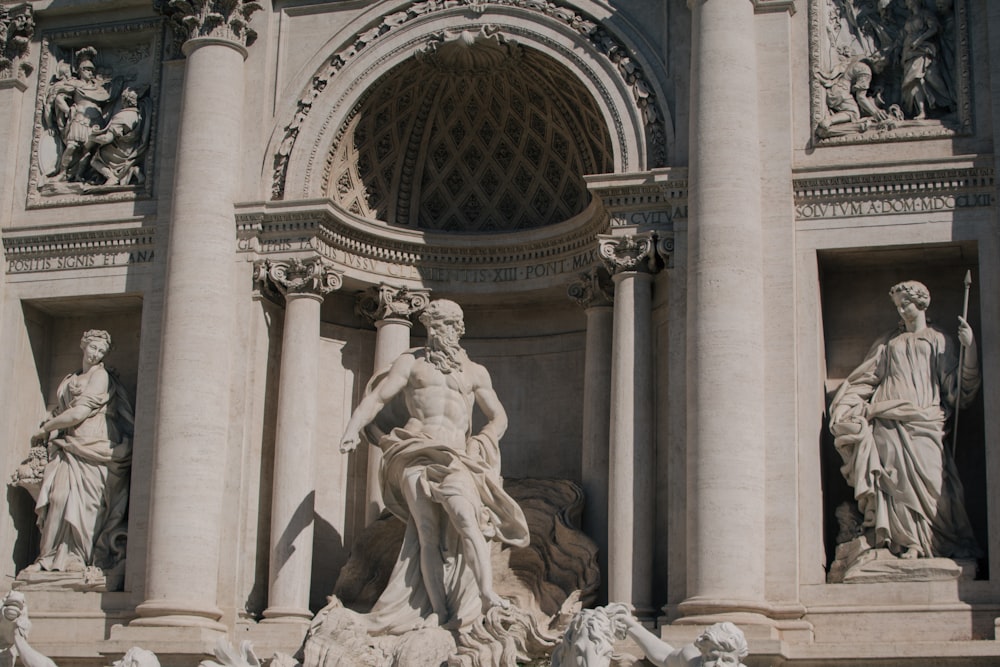 a fountain with statues on the sides of it