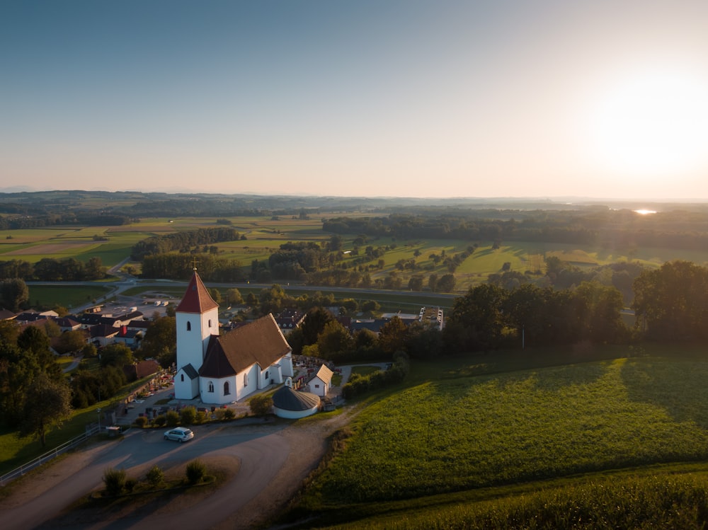 an aerial view of a church in a rural area